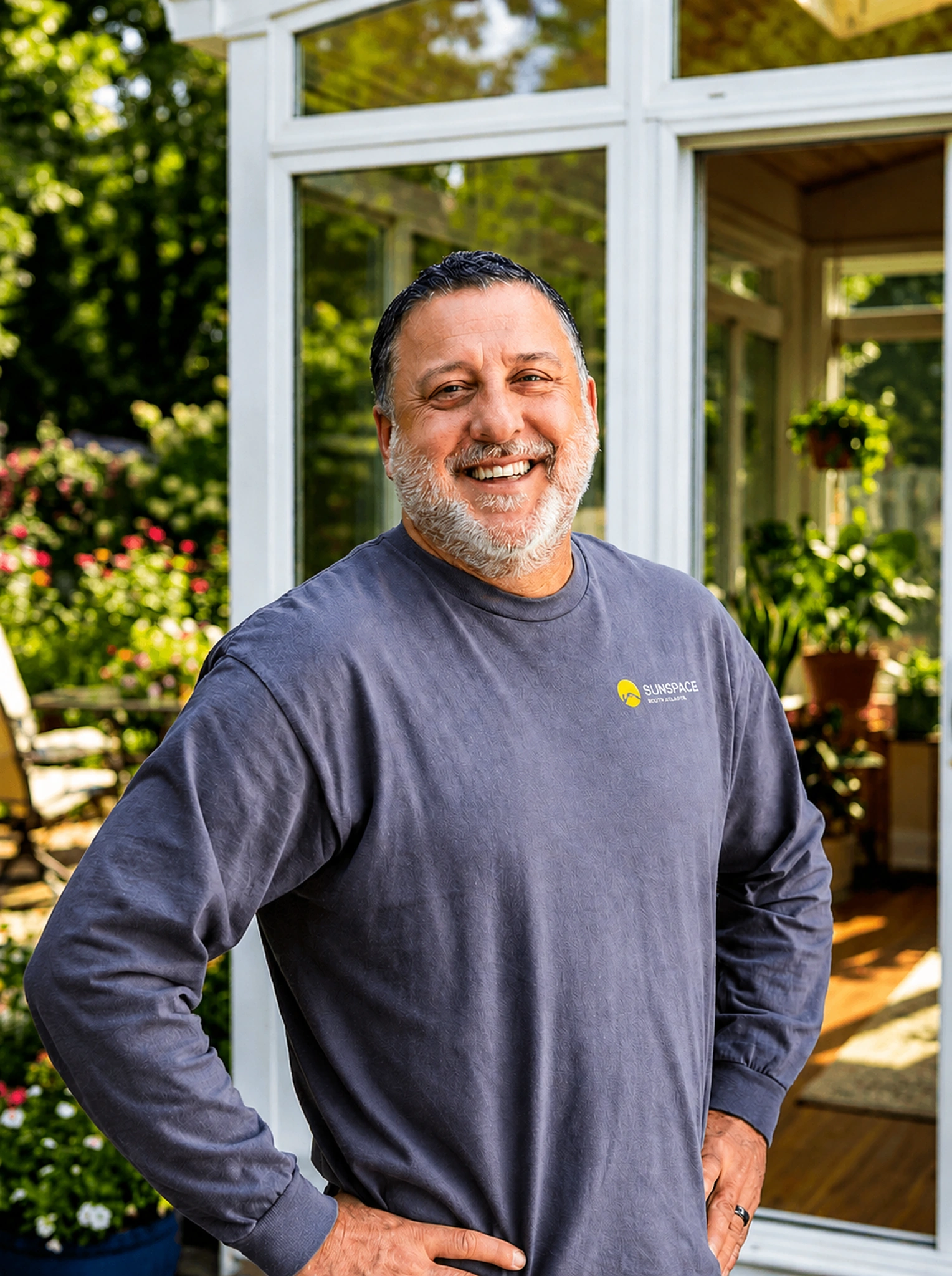 Jonathan Carter, Member of Sunspace South Atlanta, smiling outdoors in front of a Sunspace sunroom enclosure.
