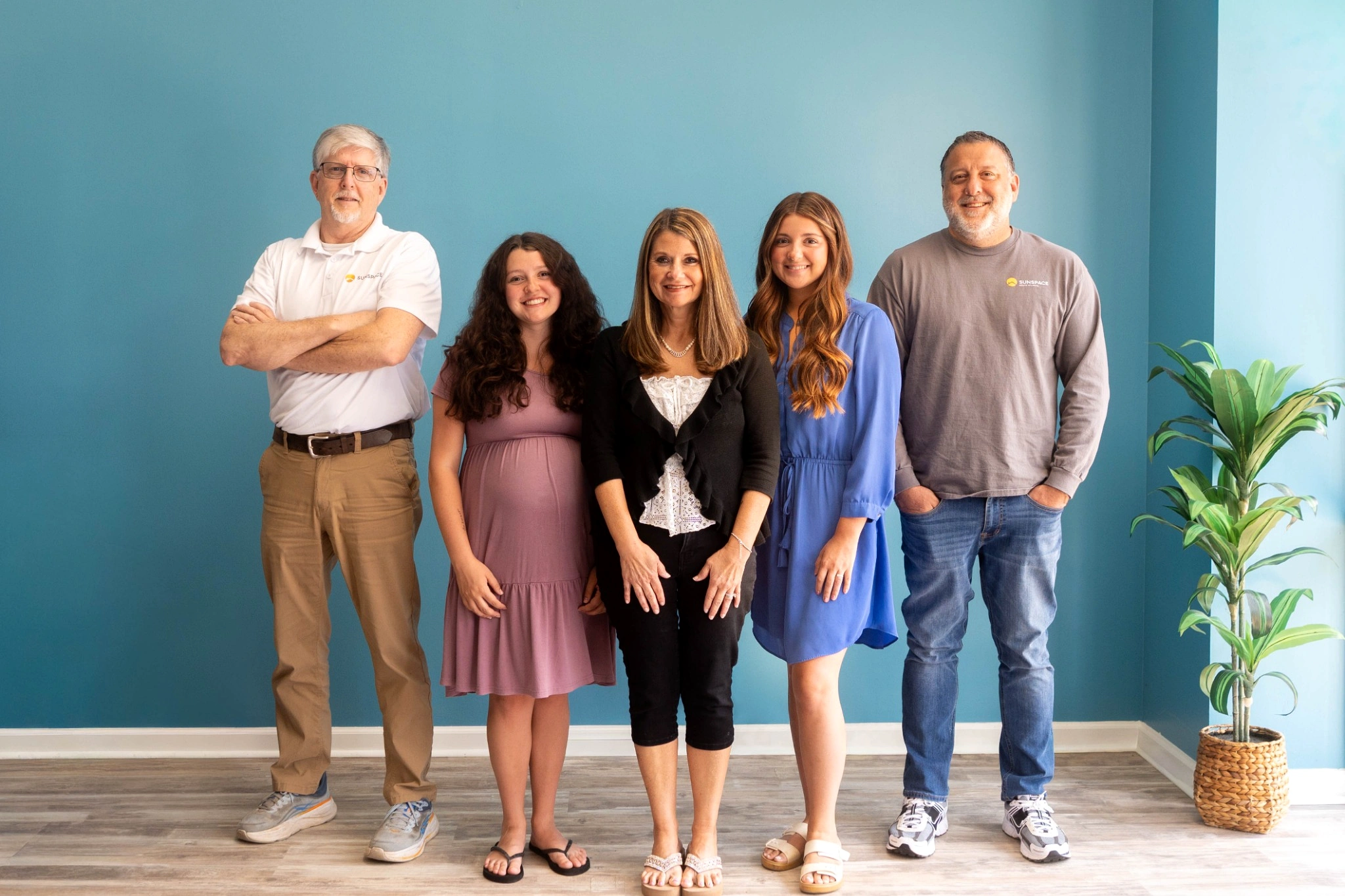 Professional Sunspace team standing together inside a modern showroom